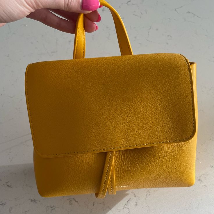 Yellow Mansur Gavriel Bag With Dust Bag And Strap. Tags Still Attached. Selling Because I Haven’t Reached For It Since Buying It Last Summer. Price Negotiable Within Reason. I Will Include The Farfetch Receipt With Purchase And Poshmark Will Authenticate It For Free. Classic Yellow Satchel With Top Carry Handle, Classic Yellow Satchel With Detachable Handle, Classic Yellow Shoulder Bag With Top Carry Handle, Classic Yellow Top Handle Bag, Modern Yellow Bag With Top Carry Handle, Yellow Crossbody Bag With Top Carry Handle, Modern Yellow Bags With Top Carry Handle, Yellow Top Handle Satchel With Removable Pouch, Modern Yellow Top Handle Satchel