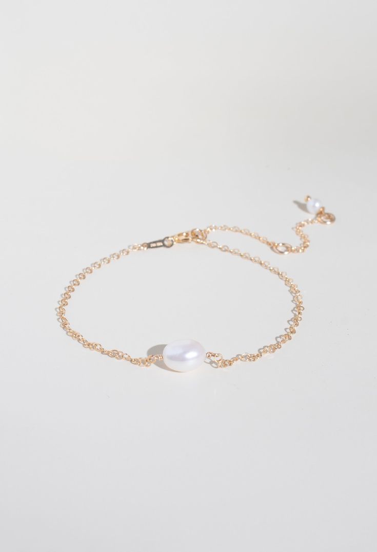 Make a statement with this stylish Solo Pearl Bracelet! Its single pearl and cable chain design is an eye-catching accessory for any look. Upgrade your wardrobe with this versatile piece that you can easily dress up or down! Material: 14k Gold Filled Gemstone: 6mm fresh water pearl Chain style: Cable Size: adjustable 5.5-8" Handcrafted Water resistant Hypoallergenic and Tarnish resistant Classic Pearl Bracelet With Extender, Elegant White Chain Bracelet With Pearl Drop, Elegant White Pearl Bracelet With Extender, Classic White Chain Bracelet With Pearl Drop, Classic White Pearl Chain Bracelet, Minimalist Pearl Bracelet With Adjustable Chain, Classic Pearl Bracelets With Adjustable Chain, Minimalist White Chain Bracelet With Pearl Drop, Elegant Pearl Bracelet With Extender As Gift