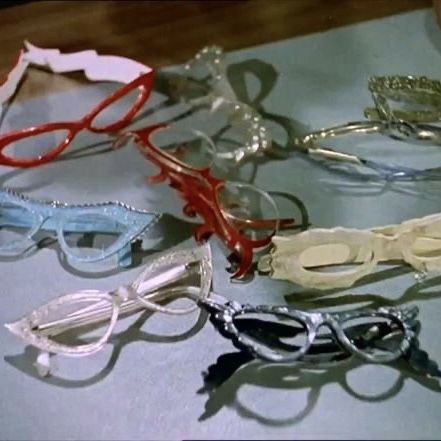 several pairs of glasses sitting on top of a table