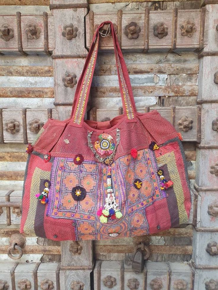 a red purse hanging on a wooden door