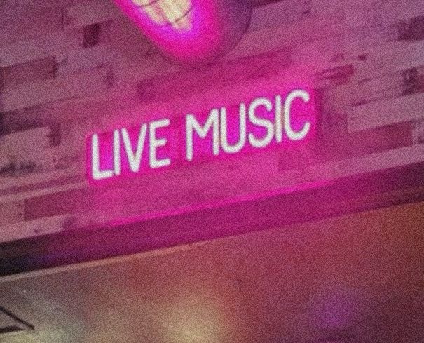 a neon sign that reads live music on it