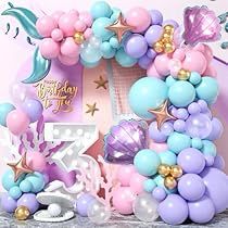 the balloon arch is decorated with pastel colors