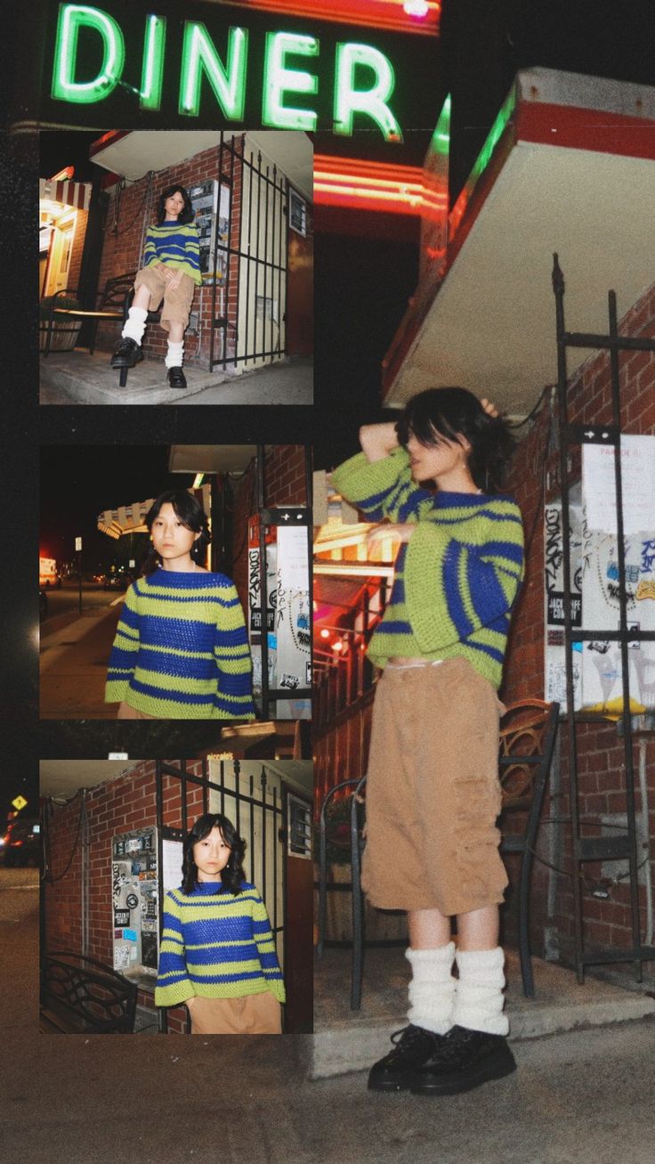 a woman standing in front of a diner with her hand on her head and wearing a striped sweater