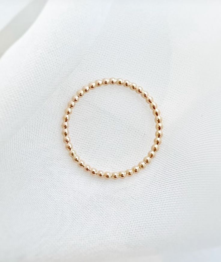 Wear one or many! These amazing stackers add the perfect dainty detailing to any outfit. Details: +Sterling Silver or Gold Fill options +Small bead-like details around entire band +1.5mm width Stackable Dainty Midi Rings With Round Band, Dainty Stackable Midi Rings With Round Band, Stackable Dainty Midi Rings, Dainty Adjustable Stackable Rings, Dainty Stackable Round Band Bracelets, Adjustable Dainty Stackable Rings, Dainty Stackable Round Band Jewelry, Dainty Stackable Beaded Bracelets In 14k Gold, Dainty Stackable 14k Gold Beaded Bracelets