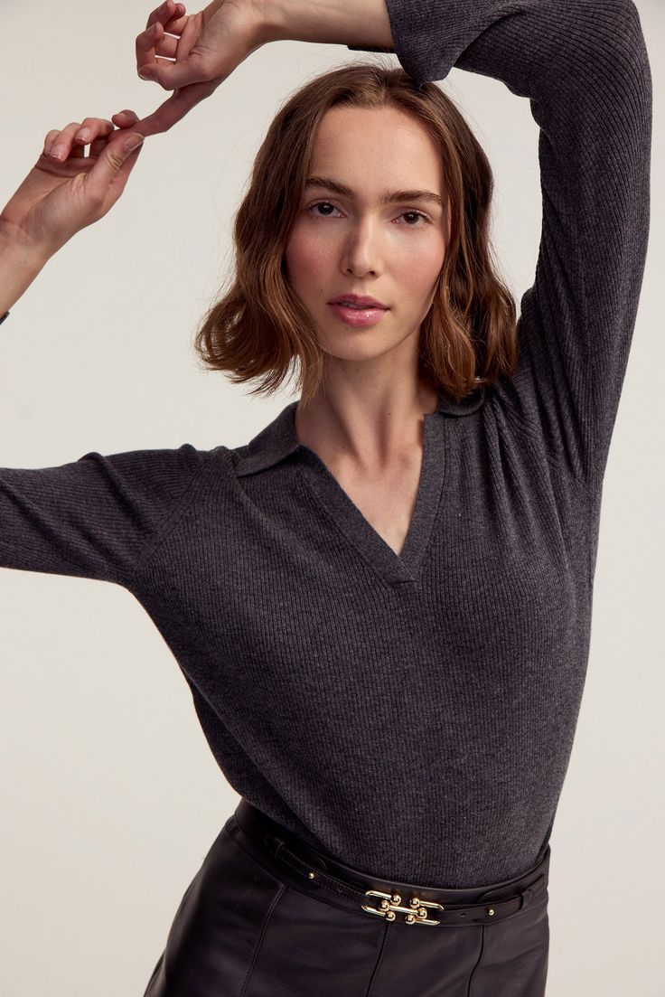 A sweater silhouette designed for versatility and enduring style. Featuring a classic collar with a V-neck for a touch of femininity, this sweater offers both comfort and sophistication. With its long sleeves and a ribbed knit texture, the sweater is ideal for all types of weather and perfect for layering. It's a wardrobe essential that effortlessly transitions from season to season. Product DetailsModel 5'10" wearing a size SMaterials: 90% Wool 10% CashmereCare: Dry Clean Only Fitted V-neck Polo Sweater With Seamless Collar, Classic Fitted V-neck Polo Sweater, Chic V-neck Knit Polo Sweater, Long Sleeve Cashmere V-neck Sweater For Work, Classic Fitted V-neck Sweater, Elegant Long Sleeve Fine Knit V-neck Sweater, V-neck Polo Sweater For Work, Classic V-neck Sweater With Ribbed Cuffs, Fitted V-neck Sweater With Ribbed Cuffs For Winter