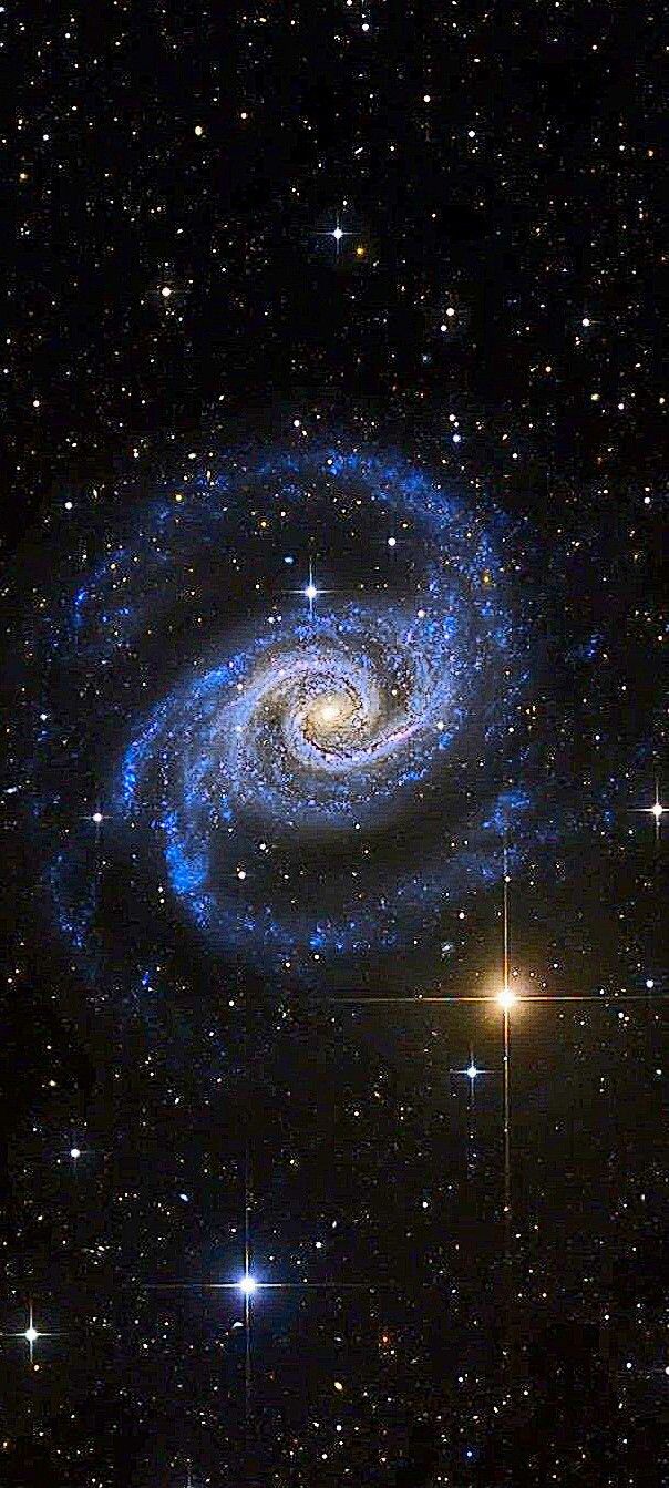 a spiral galaxy with stars in the background