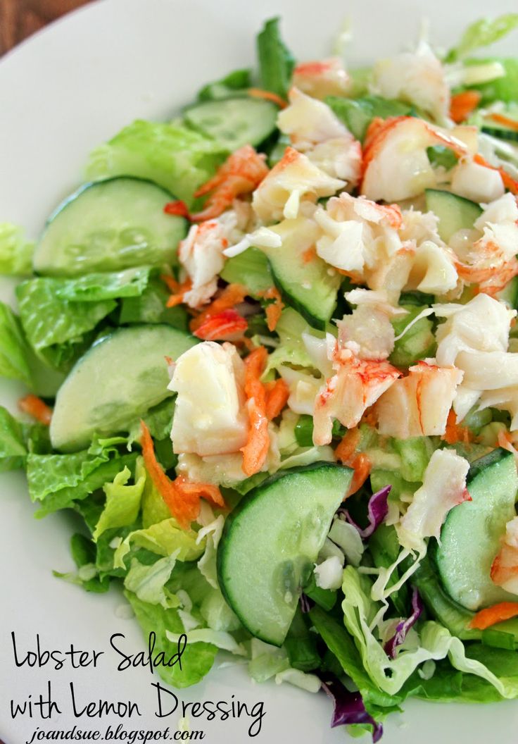 a salad with cucumbers, carrots and lettuce on a white plate