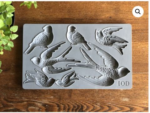 a metal plaque with birds on it