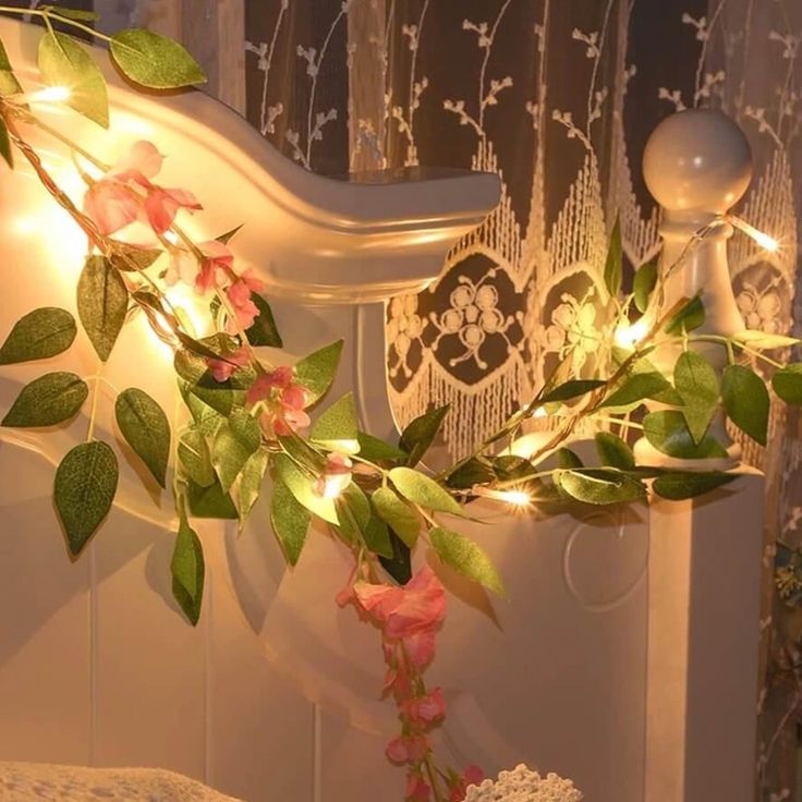 a bed with flowers and lights on the headboard