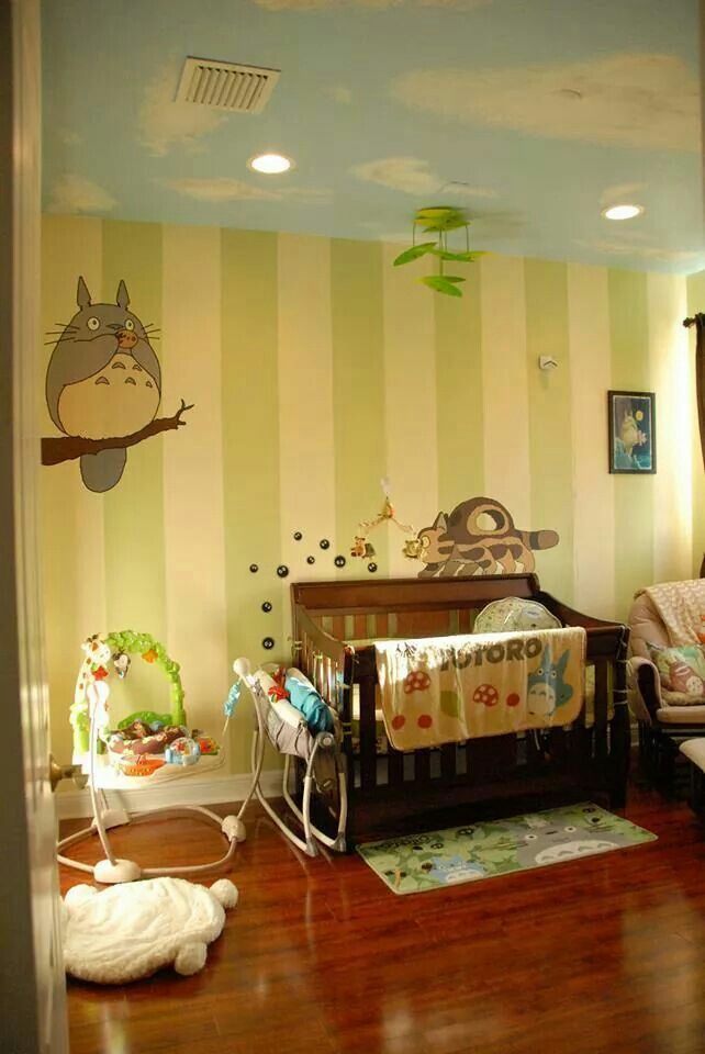 a baby's room with a crib, rocking chair and wall decals