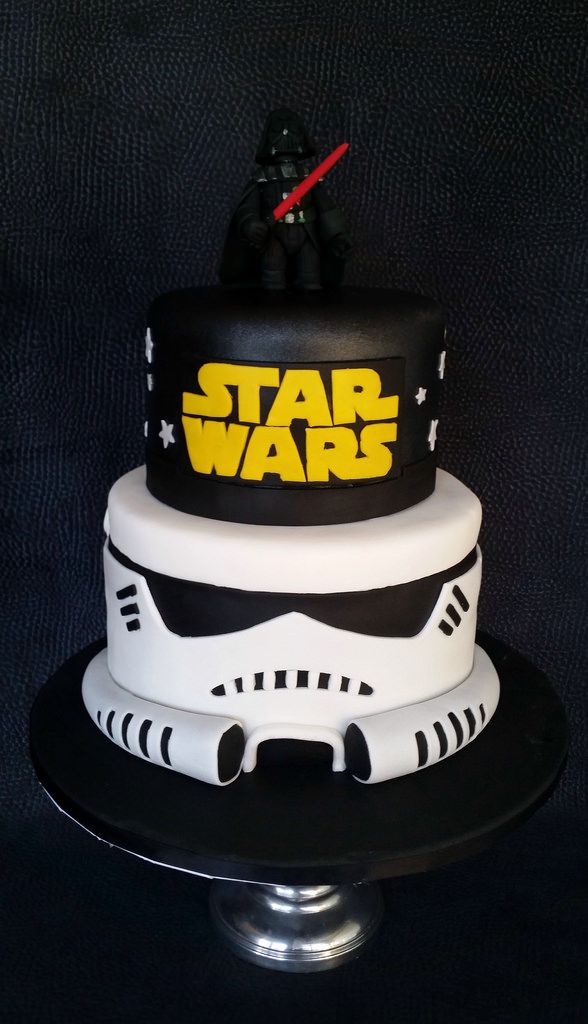 a star wars themed cake on a black table