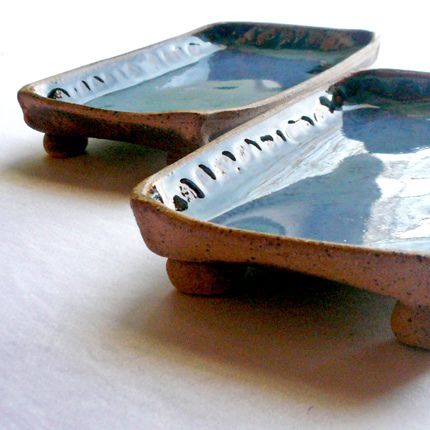 two ceramic bowls sitting on top of a table