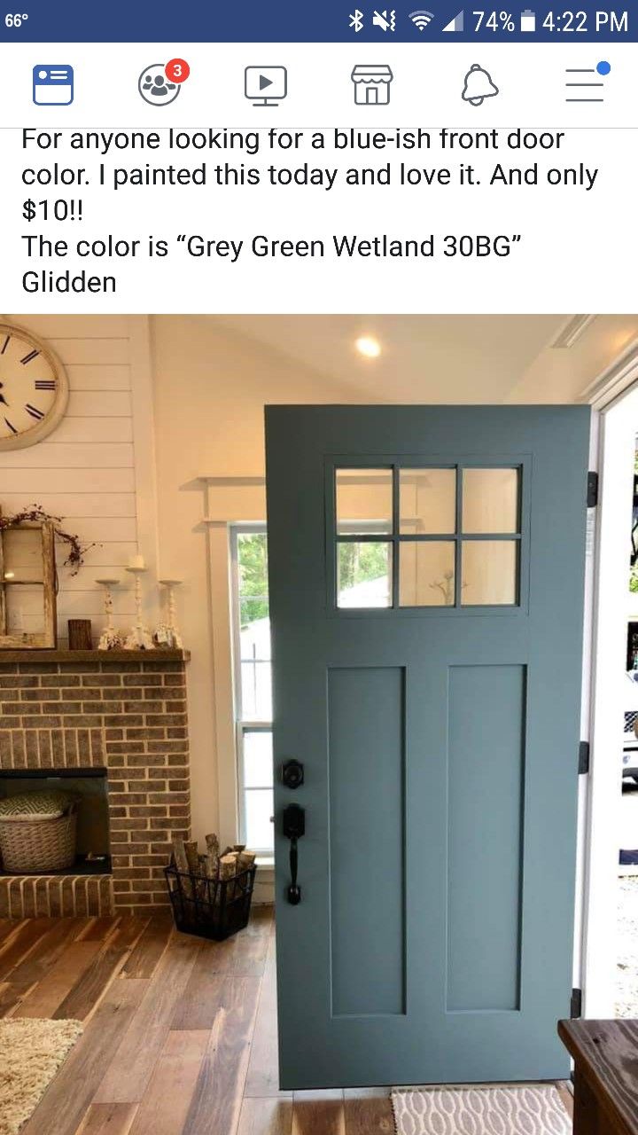 a blue front door in a house with hardwood floors