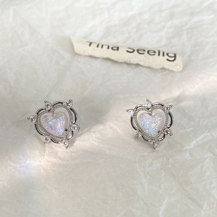 Add a touch of elegance and sparkle to your special day with these exquisite Sparkling Opal Heart Shape With Diamond Stud Earrings. These unique and timeless earrings feature a minimalist design crafted from high-quality silver with sparkling opals and diamond studs. Perfect for bridal earrings, these earrings will make a stunning statement piece that is sure to turn heads.The perfect gift for her, these earrings are the perfect choice for any special occasion such as birthdays, anniversaries, w Elegant Heart Earrings With Sparkling Stones For Valentine's Day, Elegant Sparkling Heart Earrings In Cubic Zirconia, Elegant Sparkling Cubic Zirconia Heart Earrings, Elegant Sparkling Heart Earrings For Valentine's Day, Valentine's Day Elegant Heart Earrings With Sparkling Stones, Elegant Valentine's Day Heart Earrings With Sparkling Stones, Elegant Silver Heart Earrings, Elegant Silver Sparkling Heart Earrings, Silver Heart Earrings With Sparkling Stones