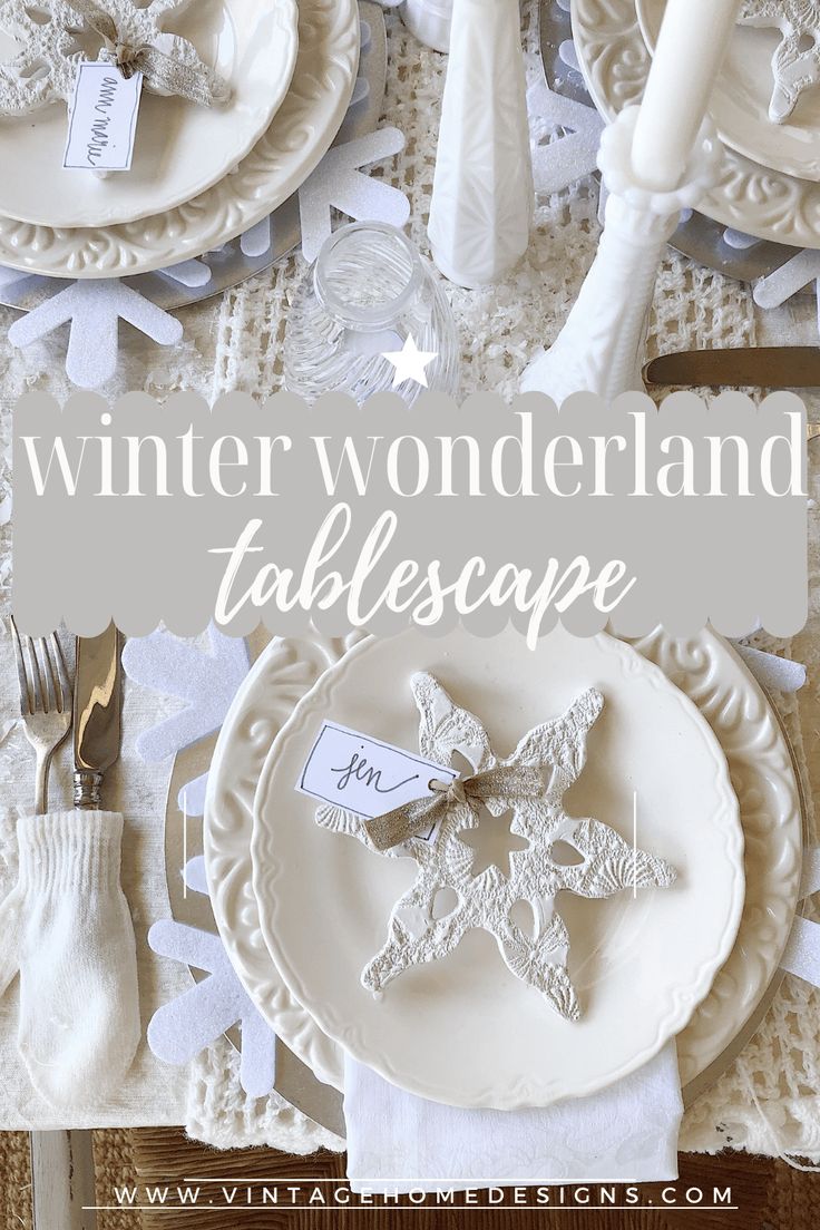 the table is set for winter wonderland with place cards and napkins on it, along with silverware