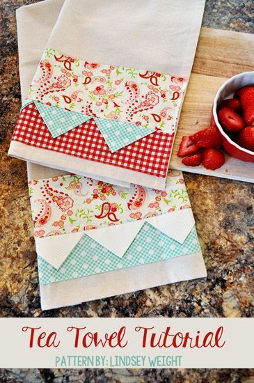 the tea towel is sitting next to some strawberries on a cutting board and bowl