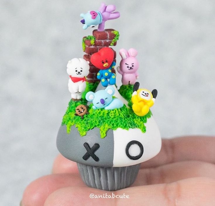 small toy animals sitting on top of a cupcake