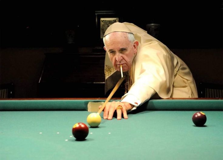 a man leaning over a pool table with two cues in his mouth and one hand on the cue