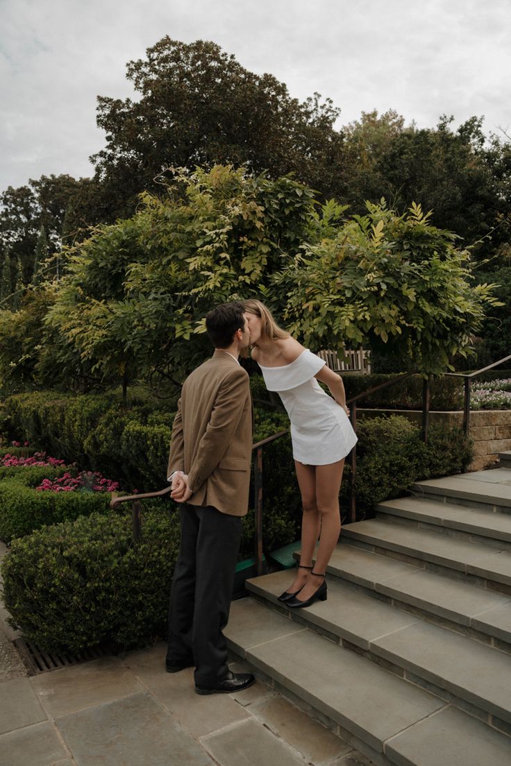 a man and woman kissing on the steps