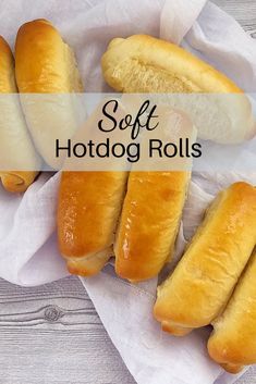 four hotdogs sitting on top of a white napkin