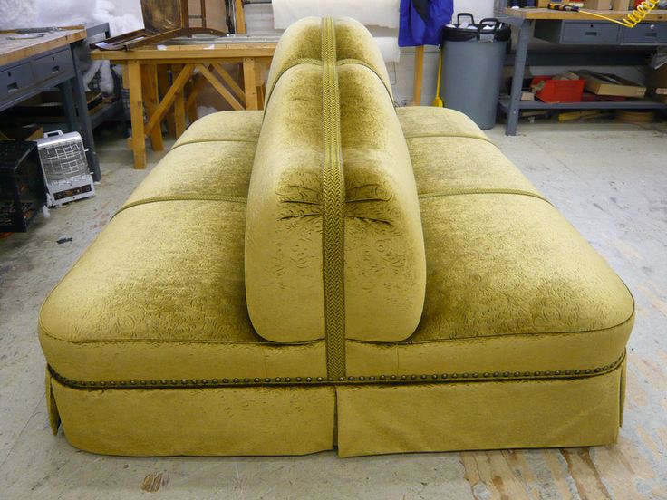 a yellow couch sitting on top of a wooden floor