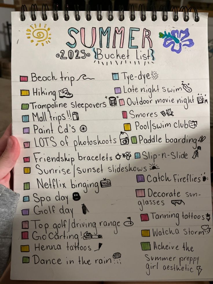 someone holding up a summer bucket list