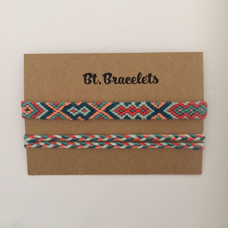 three braided bracelets with different colors and designs on brown cardboard card, against white background