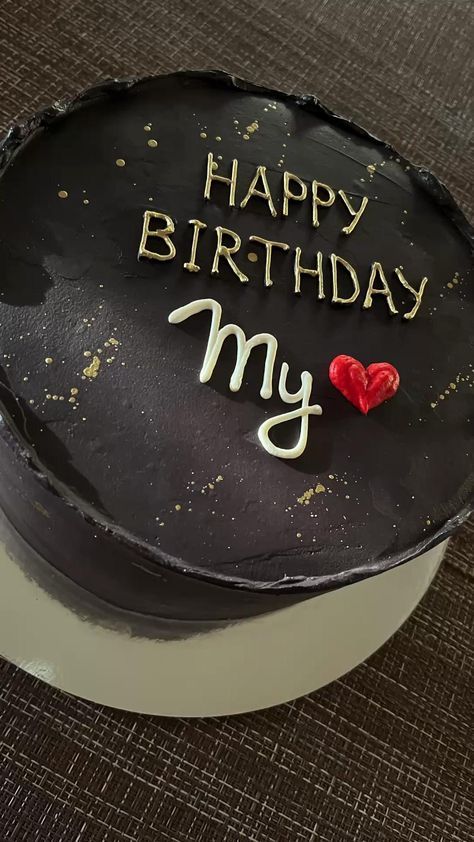 a black birthday cake with the words happy birthday my on it and a red heart