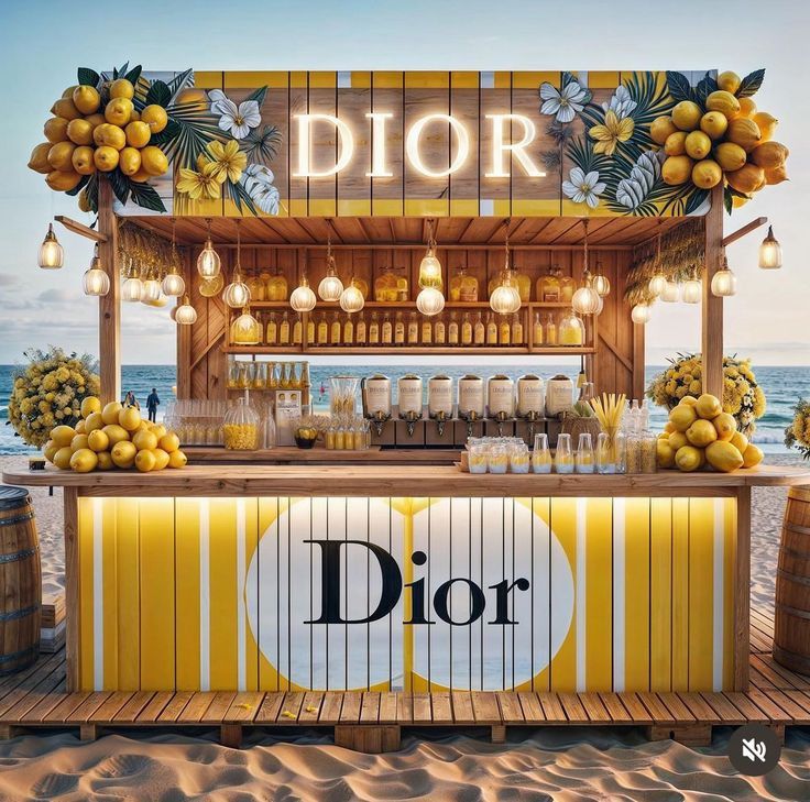 a dior lemonade stand on the beach with lots of lemons around it