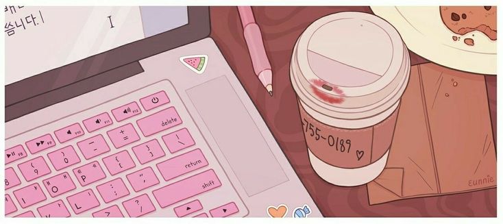 a cup of coffee sitting on top of a laptop computer next to a pink keyboard