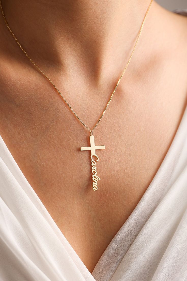 "Cross Name necklace is one of our favorite design for Baptism. Also perfect for daily use. It can become your Great option as Baptism gifts or Christian gift for Christening. Lets personalize with any name your stylish necklace. Gold Name Necklaces & Cross Name necklaces most dainty minimalist design in the world.  💖Personalized piece for your self or for someone special in your life.. 🎁Great Dainty necklace as Mothers Day Gifts, Christian Gifts, Gift for Baptism, Christmas Gift, birthday gift, gifts for mom or any special occasion. 💖Personalize a timeless, dainty and chic personalized jewelry for yourself now.  ✋All our personalized necklaces %100 custom made by hand with Love and Care in our workshop! Nickel Free High Quality Materials *How to customize your cross necklace? Leave a n Personalized White Cross Necklace, Personalized Engraved Cross Necklace, Personalized Cross Necklace Pendant As Gift, Personalized Cross Pendant Necklaces For Gifts, Personalized Cross Pendant Necklace For Gift, Personalized Spiritual Crucifix Necklace, Cross Pendant Jewelry With Name For Gift, Personalized Gold Necklaces For Baptism, Personalized Cross Pendant Necklaces For Birthdays