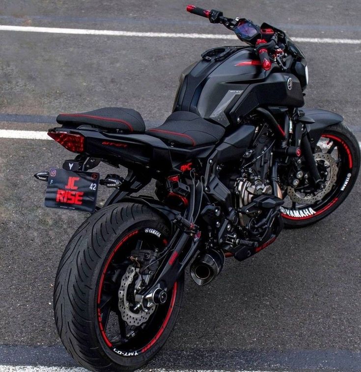 a black motorcycle parked in a parking lot