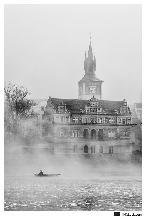 a large building with a clock tower in the fog