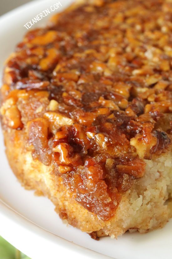 a close up of a piece of cake on a white plate with pecans in the middle