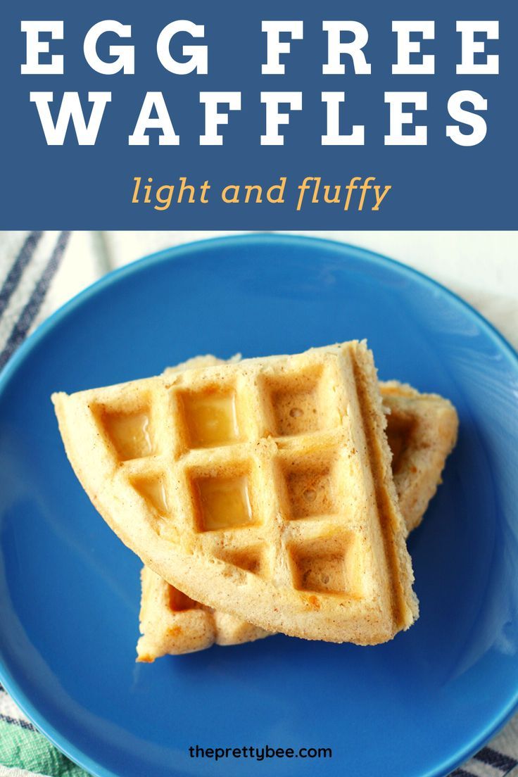 egg free waffles on a blue plate with the words light and fluffy over it