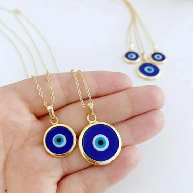 Ward off bad vibes in style with our Blue Turkish Evil Eye Necklace. Perfect for any occasion (except maybe a séance), this necklace features a stunning blue evil eye charm on a delicate chain. Keep the negativity away, all while looking fabulous. This necklace is combination of; - dark blue glass evil eye bead - stainless steel gold chain 15mm Charm Made in Turkey Blue Pendant Charm Necklace With Adjustable Chain, Blue Evil Eye Charm Necklace, Blue Evil Eye Pendant Necklace, Blue Pendant Charm Necklaces For Spiritual Style, Spiritual Blue Evil Eye Jewelry, Handmade Blue Round Charm Necklace, Blue Evil Eye Jewelry As Gift, Blue Evil Eye Jewelry Gift, Spiritual Blue Charm Necklace With Adjustable Chain