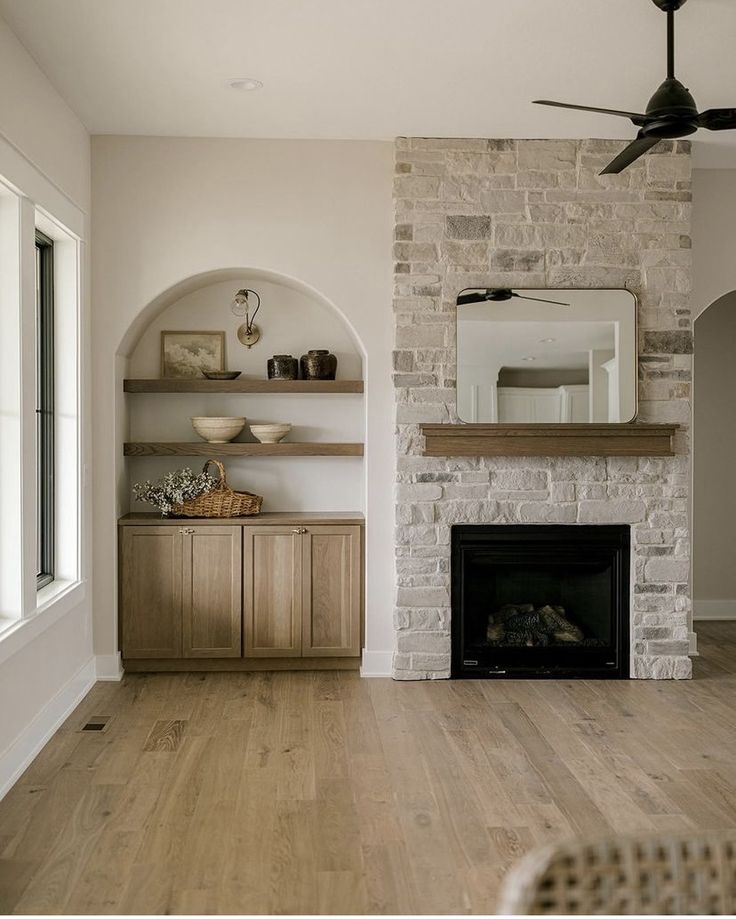 a living room filled with furniture and a fire place in front of a brick fireplace