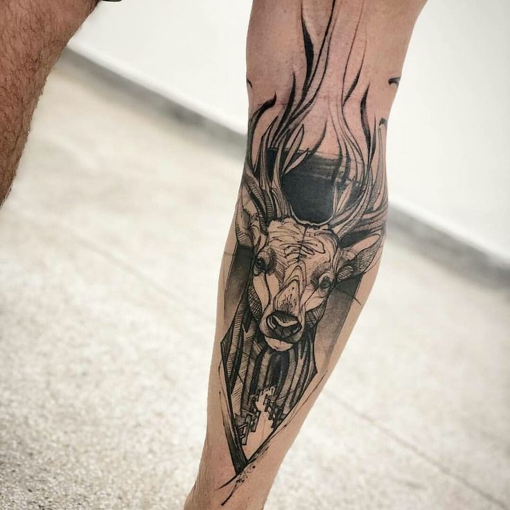 a man's leg with a deer tattoo on it