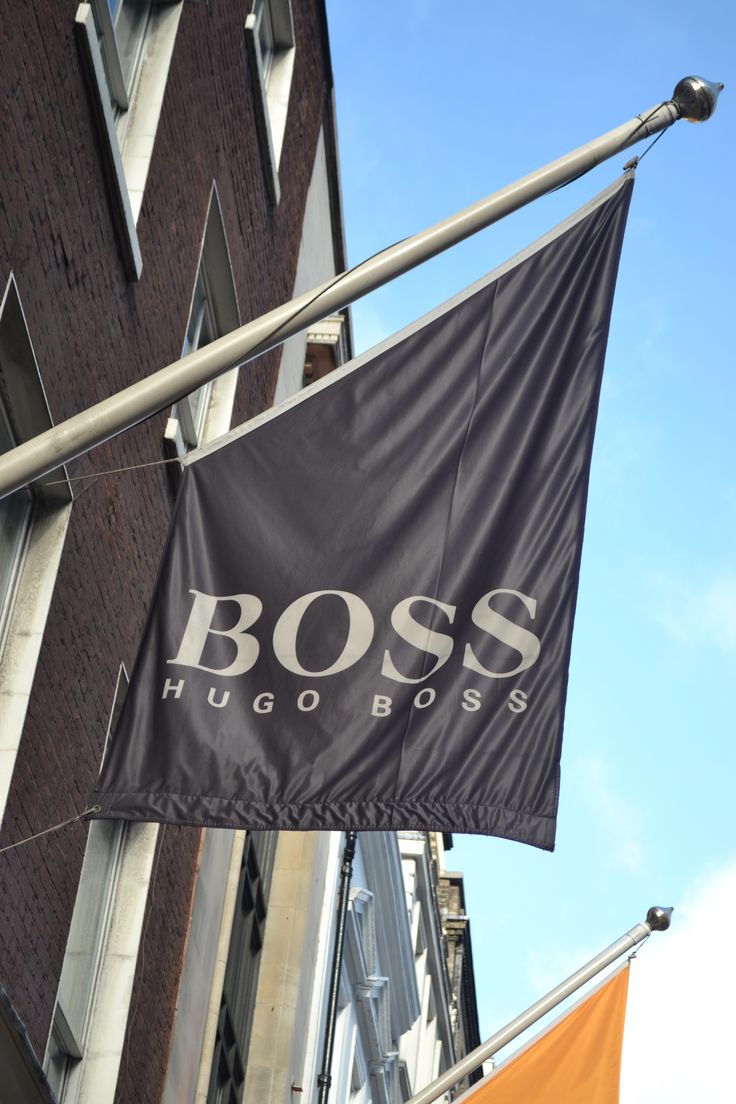 a black and white banner hanging from the side of a building