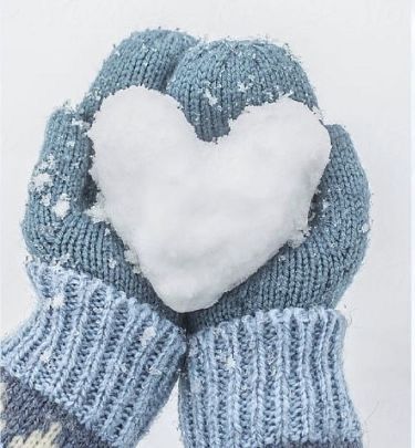 a pair of blue mittens with a white heart in the middle and snow on top