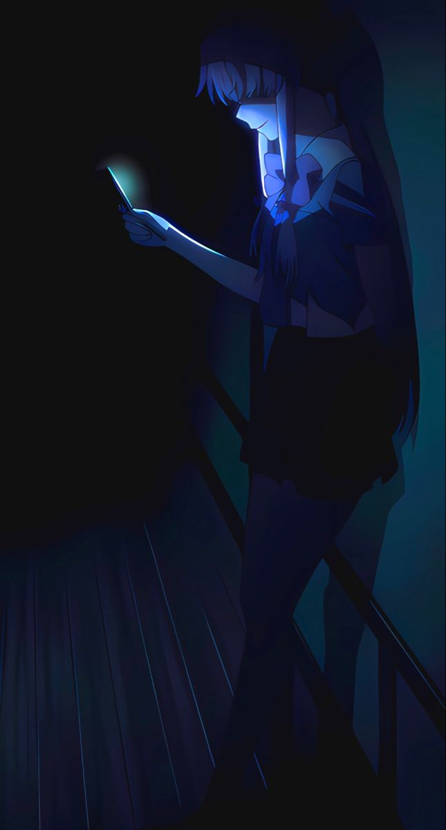 a woman holding a cell phone in the dark