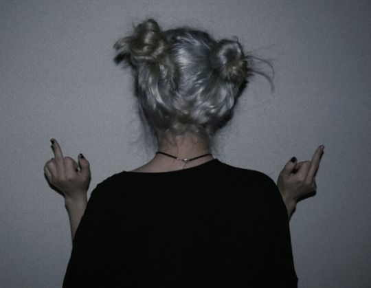 the back of a woman's head with her hands in front of her face