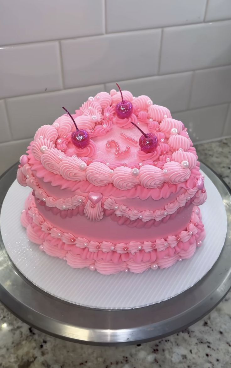 a pink cake sitting on top of a white plate