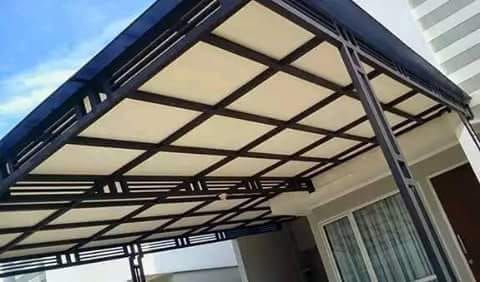 an awning over a house in front of a building with a blue sky behind it