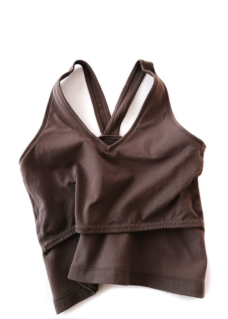 This brami is our longest style yet! The perfect combination of brami and tank with even more versatility. It's easy to wear, incredible for our long-torso girlies who need a little more length, and back smoothing. If you're looking to feel cute and comfy at the same time, this checks all the boxes! Works like a bra, fits like a tank. Built-in Extra Lining for Chest Support Fits True to Size Body-Hugging Fit and Structured Form so You Can Wear Less Layers and Still Feel Supported Longer Length V-Neck Neckline V-Neck Back so the Straps Don't Slip or Move Over Shoulders Lightly Ribbed Stretchy Nylon/Spandex Blend Anti-itch Tag Shown Styled with Accessories from our Shop Bramis are Considered a Sensitive Item and are Not Eligible for Return or Exchange Pebby's Measurements: 5ft. 4in. 8/10 in Fitted Tops With Built-in Bra For Relaxation, Brown Stretch Crop Top With Built-in Bra, V-neck Top With Built-in Bra For Everyday, Everyday V-neck Top With Built-in Bra, Supportive Racerback Top With Built-in Bra, High Stretch Camisole Tops With Built-in Bra, Fitted V-neck Top For Relaxation, Stretch Seamless V-neck Vest, Versatile Fitted Tops With Wide Straps