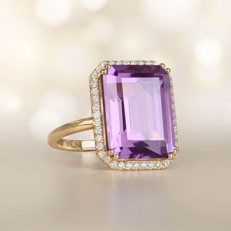 This Beautiful Gemstone Ring Centers An Emerald Cut Natural Amethyst. Luxury Amethyst Ring In Yellow Gold, Luxury Elegant Gold Amethyst Ring, Luxury Multicolor Amethyst Ring, Luxury Oval Amethyst Ring, Art Deco Style, Luxury Victorian Yellow Gold Amethyst Ring, Luxury Modern Amethyst Ring With Diamond, Luxury Yellow Gold Multi-stone Amethyst Ring, Amethyst Cocktail Ring, Estate Diamond Jewelry