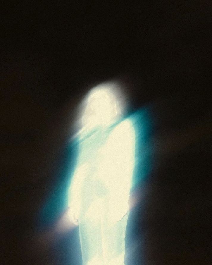 a blurry image of a person standing in the dark