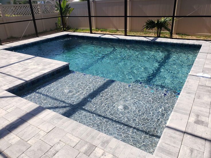 an empty swimming pool with steps leading up to it