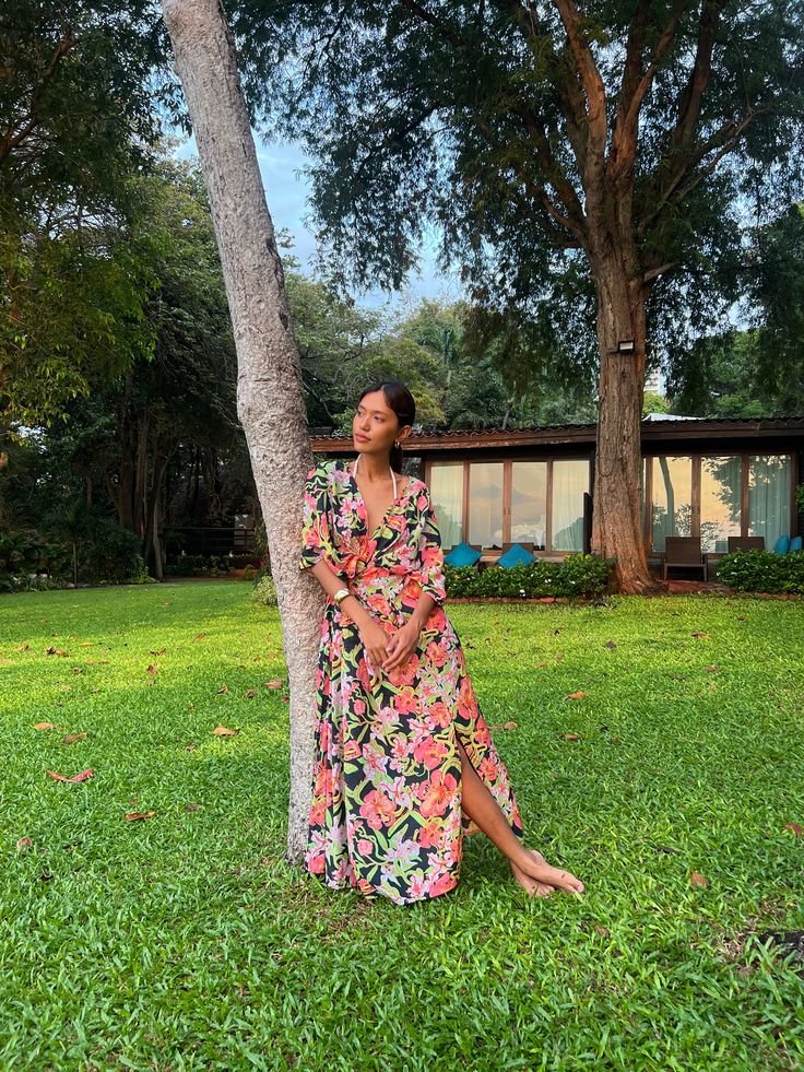 Step into the allure of our Andaman Kaftan Dress in tropical flowers print—an exquisite convergence of vibrant color and intricate design, tailor-made for your upcoming escape. Versatile in style, wear it as a beach cover, a wrapped kimono dress, or cinch it for an ethereal goddess maxi dress. Inspired by the burst of tropical flowers, including Bougainvillea, Oleander, Hibiscus, and Etlingera, our long kaftan impeccably captures the essence of nature's vivid blooms. In collaboration with the ta Tropical V-neck Maxi Dress With Vibrant Print, Beachy V-neck Floral Print Beach Dress, Beachy Maxi Dress With Tropical Print For Beach Cover-up, Tropical V-neck Maxi Dress For The Beach, Beachy Multicolor Tropical Print Maxi Dress, Tropical Floral Print Vacation Dresses, Beachy Multicolor Maxi Dress With Tropical Print, Beachy Floral Print Dresses For Vacation, V-neck Tropical Print Beach Dress