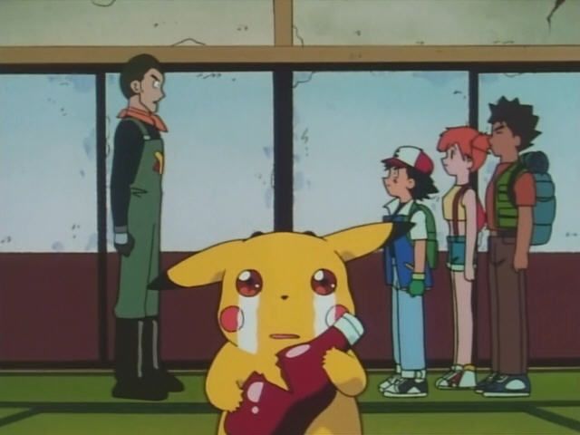 a group of people standing next to each other in front of a window with a pikachu on it